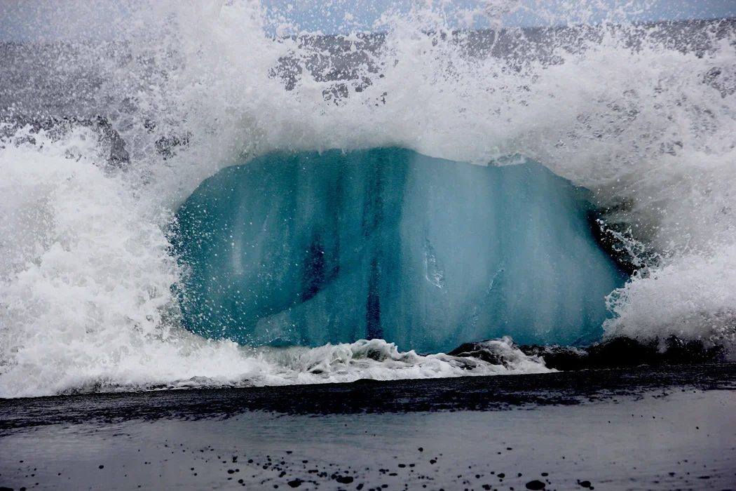 Iceberg crashing into the sea